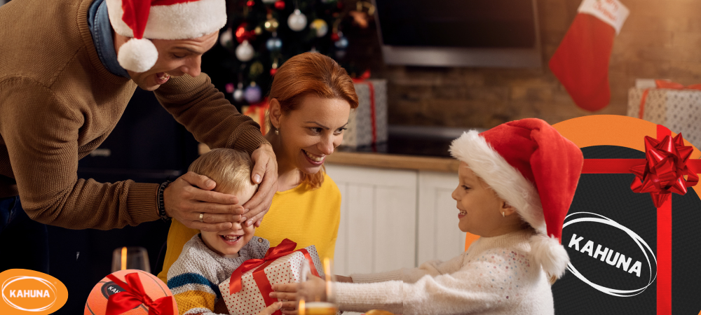 Son gives a Christmas gift to mom. Mom pleasantly surprised and